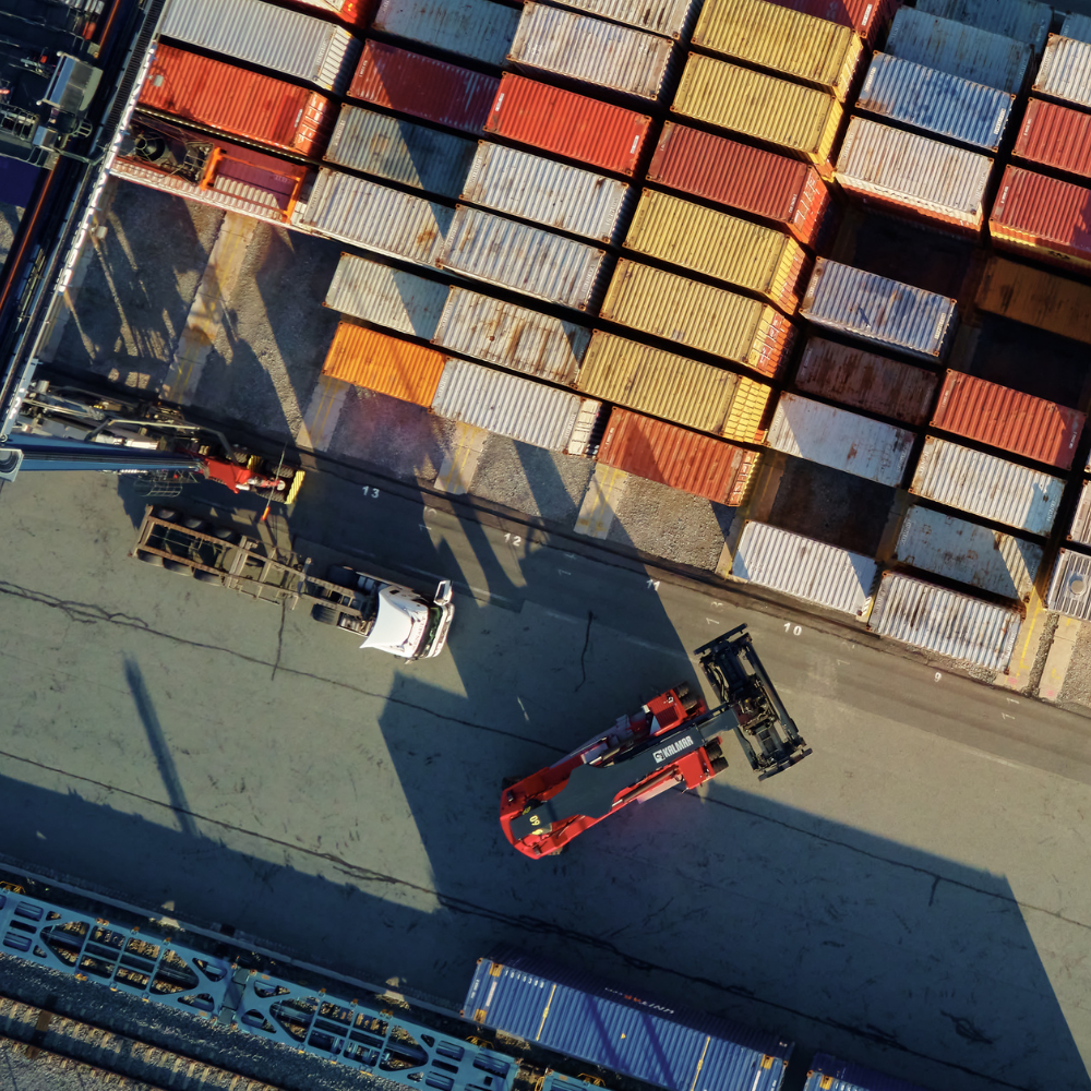a container yard with a truck and a car