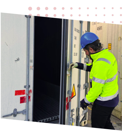 AboutUs Img a man wearing a hard hat and safety jacket opening a door
